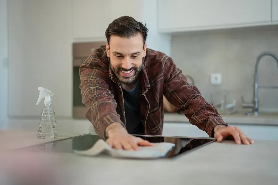 man-cleaning-cooktop